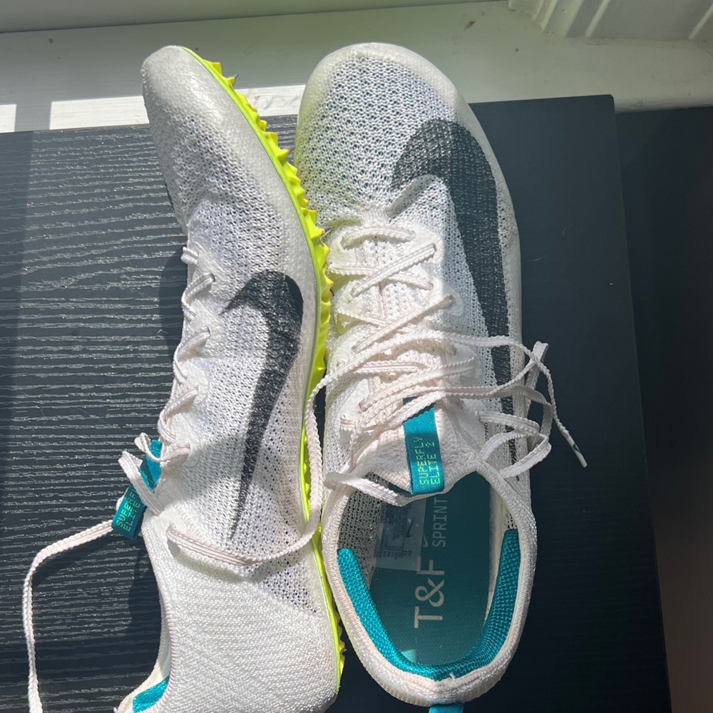 Nike White and Black Sprint Shoes with Teal Accents